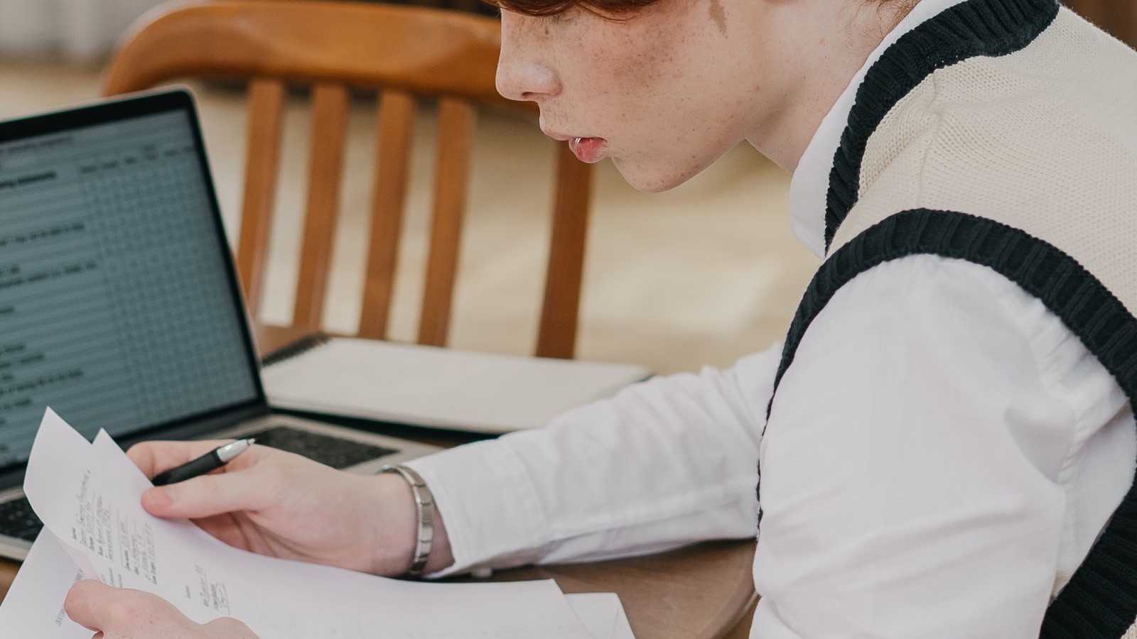 Estudiante comprobando documentos académicos antes de matricularse
