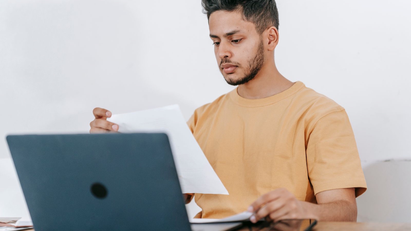 Estudiante revisando documentos y condiciones antes de pagar una matrícula